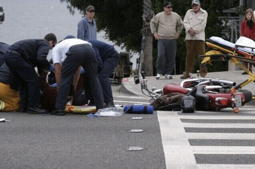 Injured-person-aided-roadside-after-motorcycle-crash-scene
