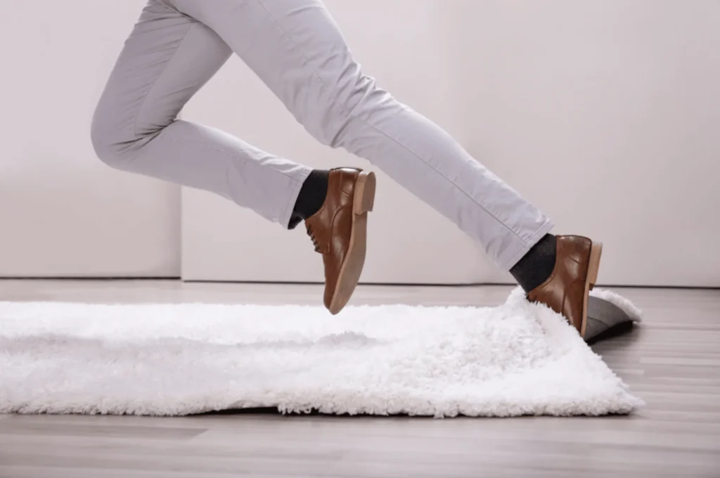 man-tripping-on-white-rug